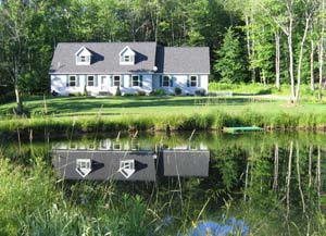 house reflected in pond