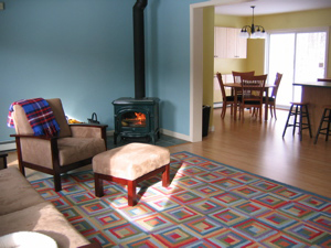 living room, fire in woodstove looking toward dining room